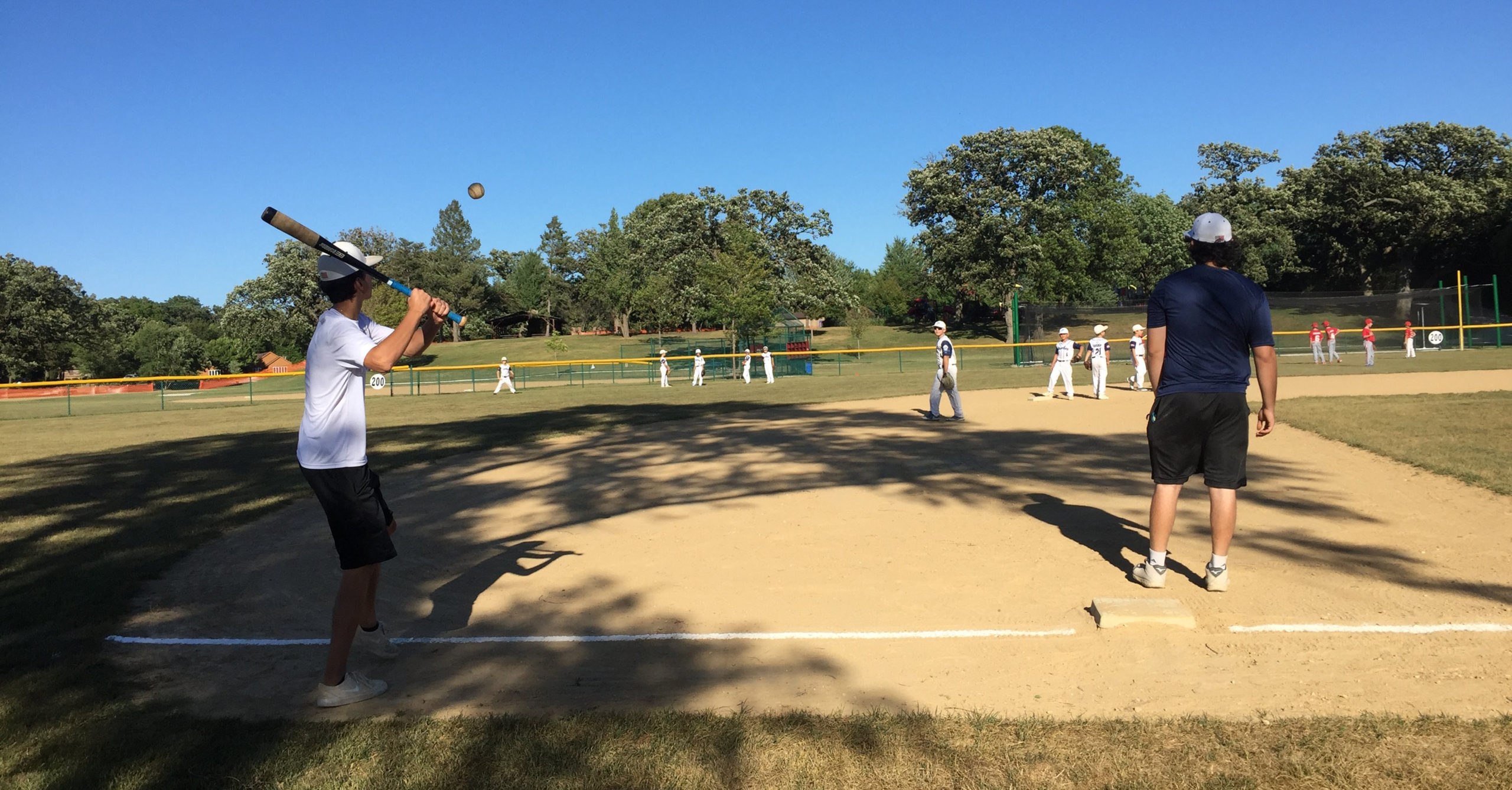 Little League teams warm up at Diecke Park before a game Thursday evening. The park will be the site Saturday evening of a drive-in fireworks show. Viewers will be asked to stay in their cars and practice social distancing during the event.