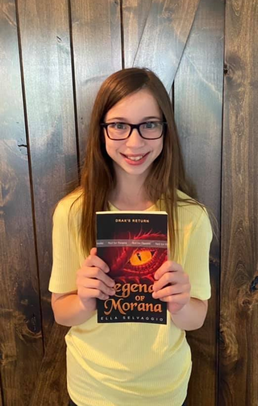 Ella Selvaggio holds a copy of her newest book now available on Amazon