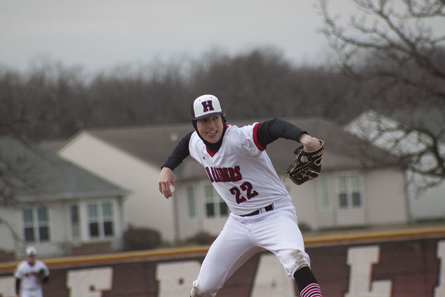 Huntley senior pitcher Adam Guazzo fires a strike against Harvard. The Red Raiders beat Harvard 7-0 in cold conditions March 29 at HHS.