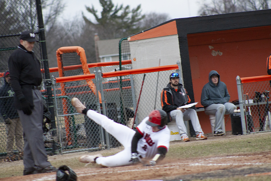 Huntley's Brandon Bakes slides safely at home plate as he scores a run for the Red Raiders against Crystal Lake Central. HHS won 5-0 April 4.