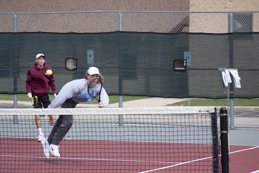 Huntley No. 1 doubles players Ben Hein tries for a return against Hononegah and partner Mat Grubbs is in back.