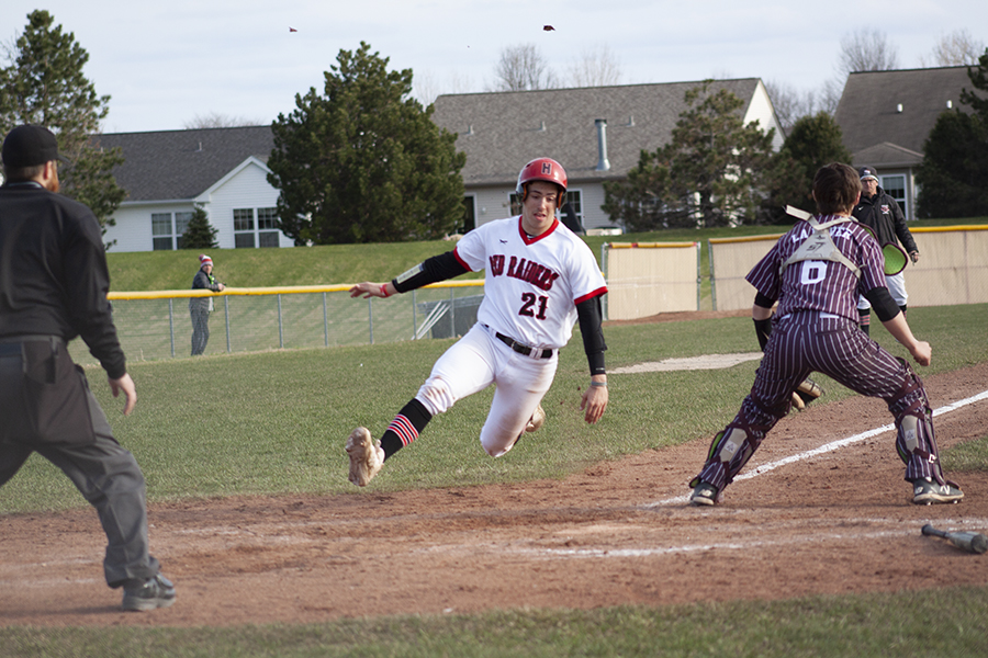 Huntley's CJ Filipek slides at home plate for a run against Prairie Ridge April 19. HHS won 10-0 in five innings.