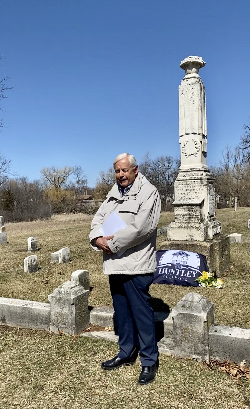 John Huntley, the great-grandson of Thomas Stillwell Huntley standing next to the Huntley family gravesite