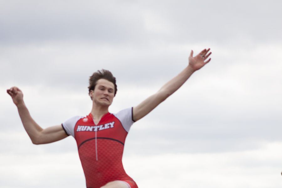 Huntley's Jayden Bell leaps in his long jump effort at the HHS triangular May 2 against Cary-Grove and Jacobs.