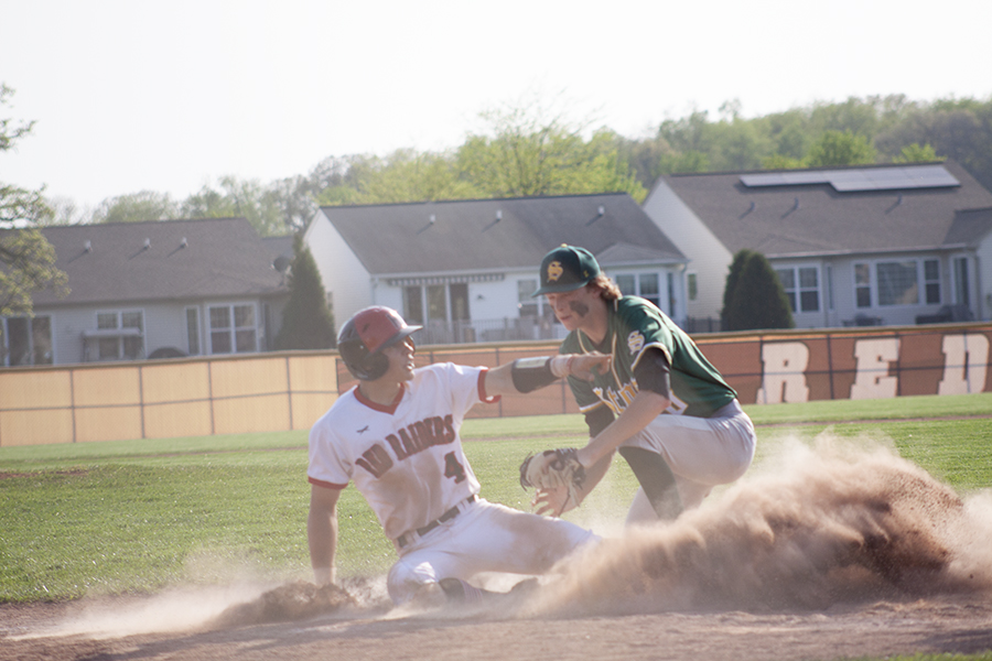 Huntley's Ryan Quinlan slides at home plate against Crystal Lake South. The Red Raiders won 6-4 to earn the Fox Valley Conference championship.