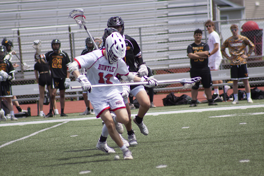 Huntley's Jeremy Hollow battles a Schaumburg player for control in a late-season match. HHS hosts its regional tournament with its first round clash against Crystal Lake South May 23.