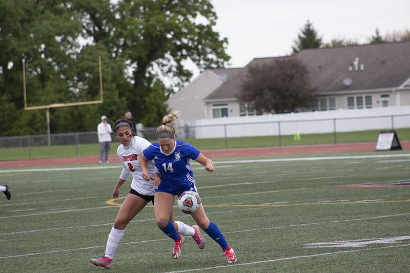 Gabriella Farraj, left, battles a Lake Zurich player in the Class 3A Regional Final match May 23