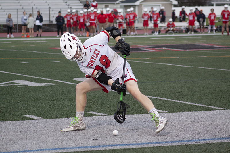 Huntley senior Dylan Gehl battles a South Elgin player for control in the Huntley Sectional Semifinal match May 25. HHS won 10-8.