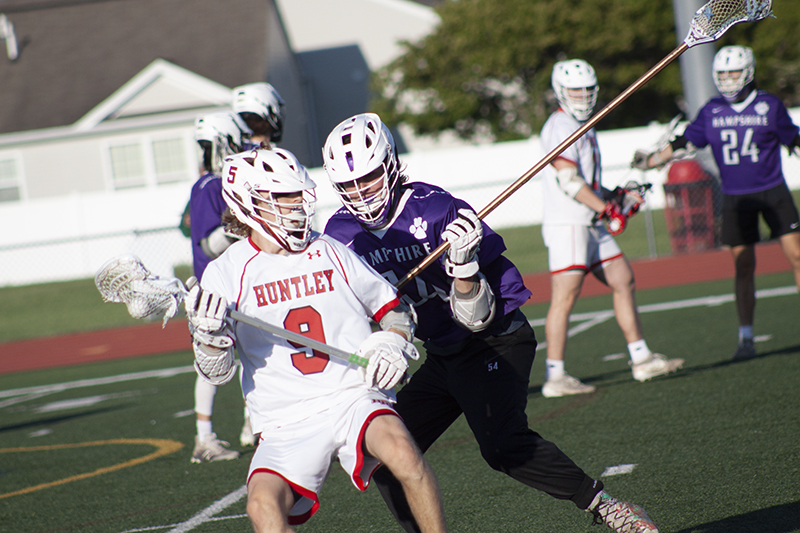 Huntley senior Andrew Toman battles a Hampshire defender during the Huntley Sectional Final. Toman scored the winning goal in a 10-9 overtime victory.