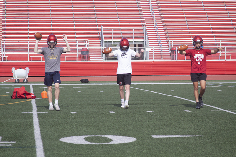 Huntley High School football players, from left, Dominic Pangallo, Luke Michael and Braylon Bower perform a drill during summer camp. The Red Raiders sports teams begin fall practices Aug. 8.