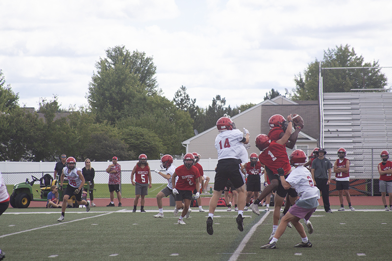 The football is a valued commodity in a Huntley play at practice. Jacob Pociecha (14) and Jack Laughlin (21) hope to catch the pass while Justin Jacobsen (2) and DaShaun Manning are on defense. Manning won the battle with an interception.