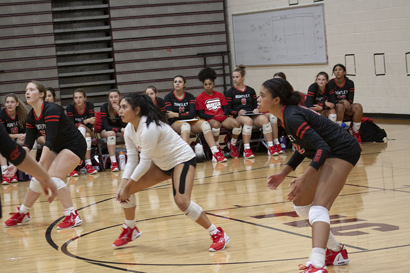 Huntley's Elizabeth Williams, Luma Acevedo and Morgan Jones are ready to receive a Prairie Ridge serve Aug. 30.HHS has a 4-0 record.