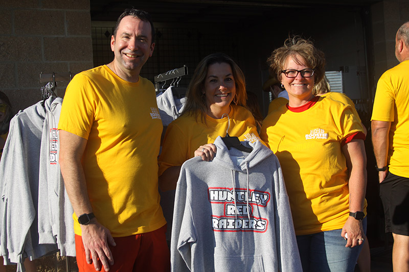 Huntley High School Booster Club members staff the concession stand and spirit wear booth at Red Raiders home football games. From left: Jay Baedke, who organizes the concessions; Booster Club President Shannon Corso and secretary Melanie Ottavino.