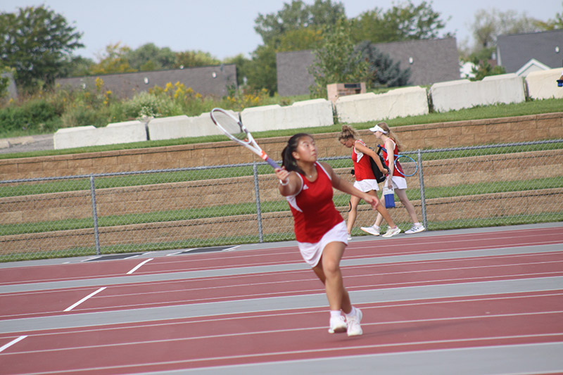 Huntley senior Emily Chang readies to return the ball in her doubles match with Delaney Stock Saturday at the Huntley Quad.