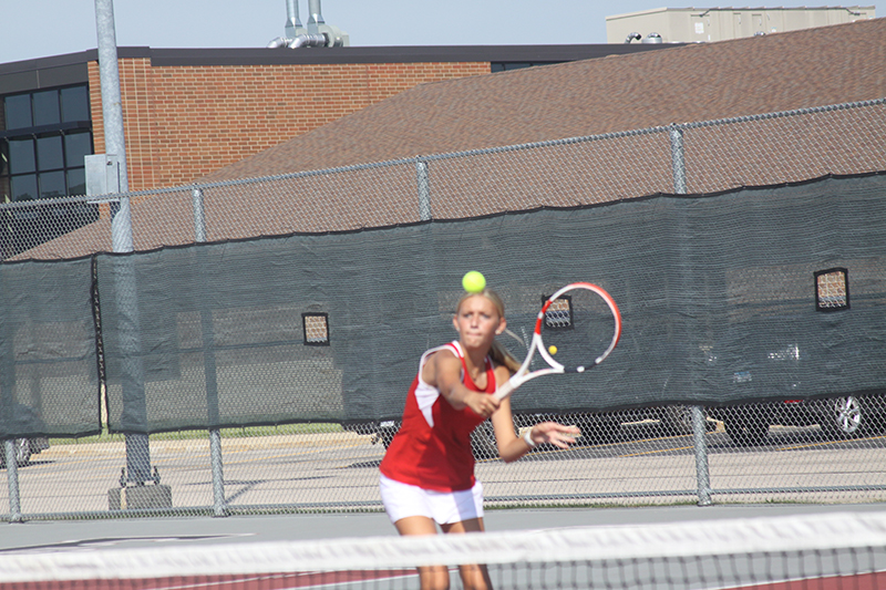 Kate Burkey of the Red Raiders returns a shot during first doubles action at the Huntley Quad Sept. 17. Burkey and Elaina Hibbeler play at first doubles.