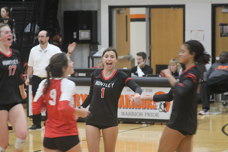 Huntley setter Maggie Duyos reached 1,000 career assists Sept. 27 at McHenry. Duyos (1) celebrates a point against the Warriors with Georgia Watson (17), Mari Rodriquez (9) and Morgan Jones(12).