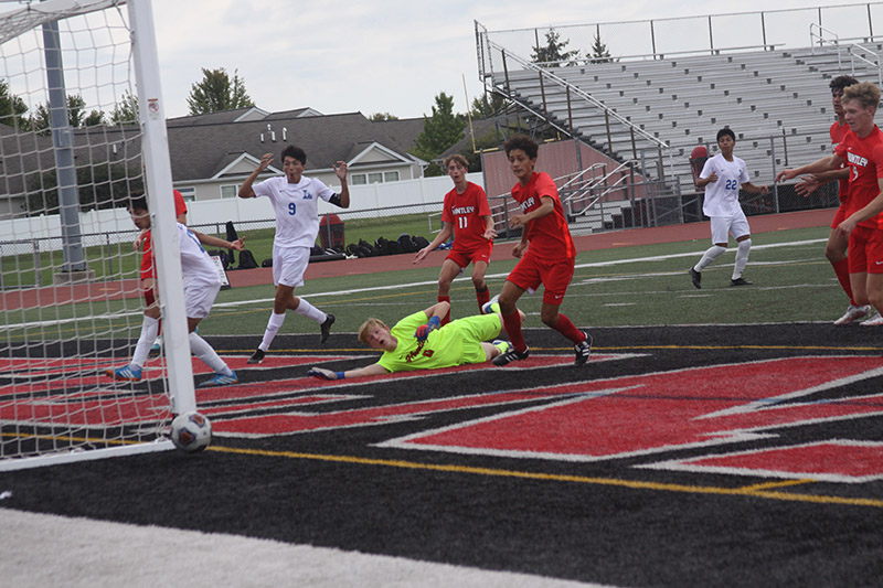 Huntley goalie Ethan Robertson knocks away an Elgin Larkin shot. Defenders Jack Hinman and Kyle Paler look on. The Red Raiders won their tournament with a 3-2 victory over the Royals Sept. 3.