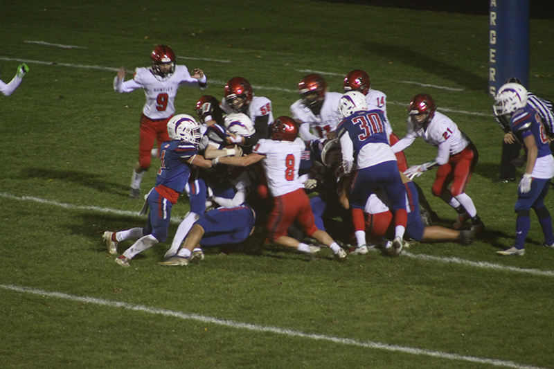 Huntley senior Joey Arvidson leads the stop of a Dundee-Crown rusher on one of two key goal-line defensive plays. The Red Raiders rallied from a 7-3 deficit at the time to a 31-19 win.