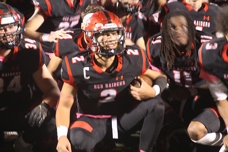 Huntley standouts from left, Haiden Janke, Sam Deligio and Dashaun Manning take part in the Red Raiders' celebration of a Fox Valley Conference co-championship. HHS beat Crystal Lake South 27-19 Oct. 21. They host Andrew at 7 p.m. Oct. 28 in the Class 8A playoffs.