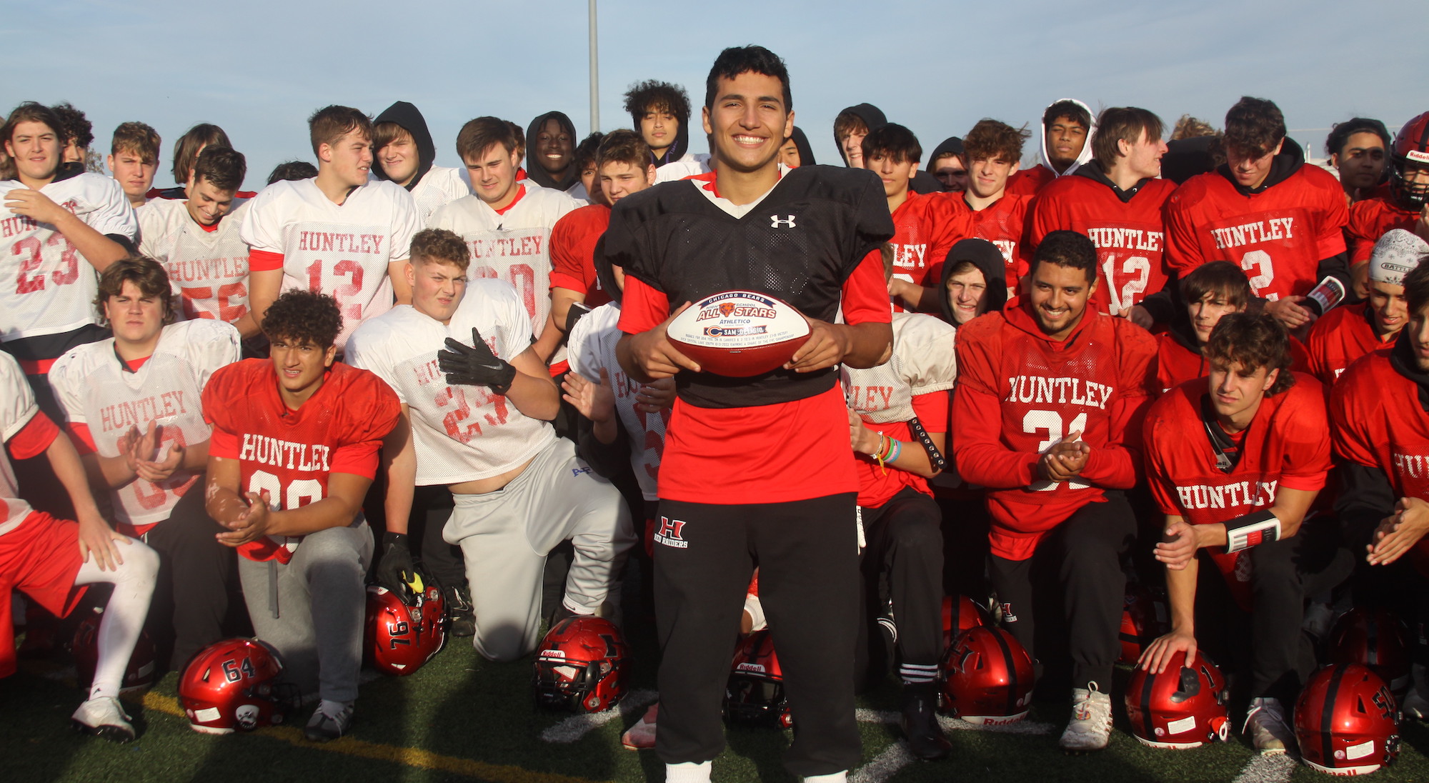 Huntley senior quarterback Sam Deligio shows the customized Chicago Bears football. He received the football as winner of the Bears High School All-Star Week 9 award. Deligio was honored after practice Oct. 27 for his 200-yard rushing, two touchdown performance in the 27-19 HHS victory over Crystal Lake South. The victory gave HHS an 8-1 record and a share of the Fox Valley Conference championship. The game occurred just days after Deligio's mom Terri died. Family members Sam's dad Andy and sister Aly Deligio attended the ceremony. Bears Manager of Youth Football Gustavo Silva said High school All-Star winners will receive two tickets to the Bears against the Philadelphia Eagles game Dec. 18 at Soldier Field as well as $500 which will be donated to an organization the player chooses.