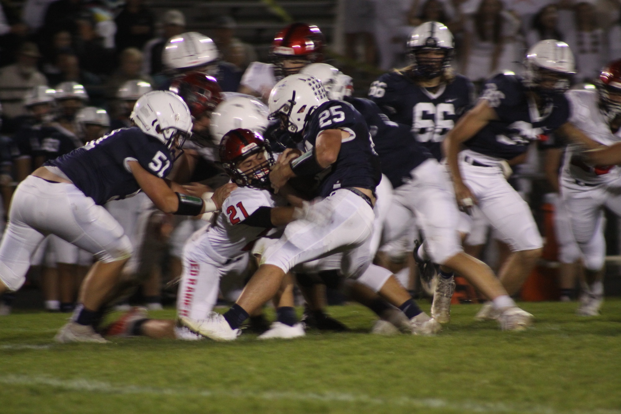 Huntley senior James Lang (21) tackles a Cary-Grove ball carrier Sept. 30. Lang had two fumble recoveries. Huntley won the Fox Valley Conference contest 17-14.