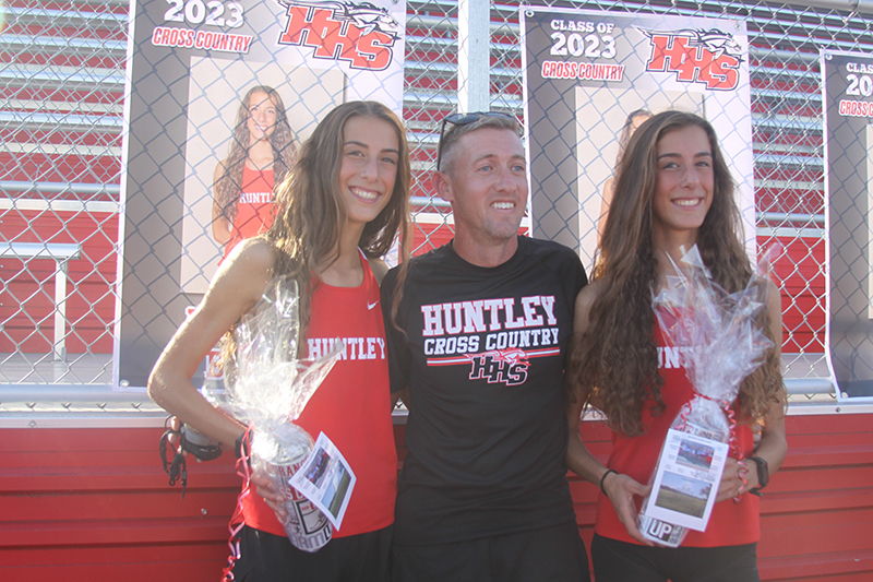 Huntley's cross country teams hosted senior night Oct. 4 at Red Raider Stadium. From left: Breanna Burak, head coach Matt Kaplan and Brittney Burak.