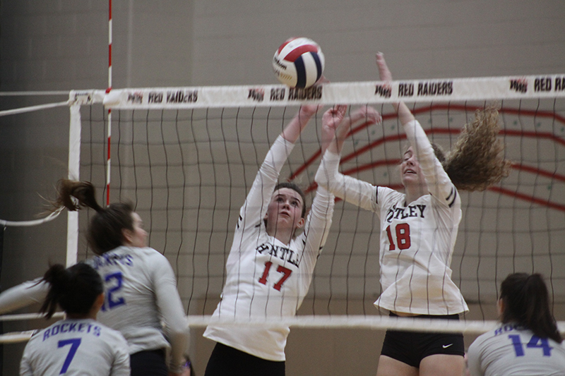 Huntley sophomore Georgia Watson, left and senior Emily Willis team up for a kill in a Fox Valley Conference victory over Burlington Central Oct. 4.