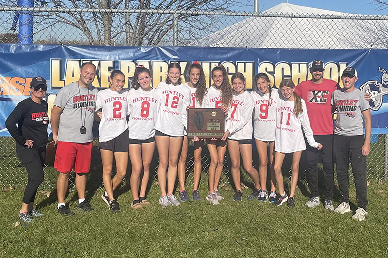 Huntley girls cross country team celebrates the Class 3A Lake Park sectional championship earned Oct. 29. From left to right: coach Brandy Swanson, coach Jason Monson, Guille Gimenez-Cunat, Ava Allison, Breanna Burak, Brittney Burak, Aspen Maldonado, Gabby Sweeney, Cori Kilvinger, coach Jimmy Jestus and coach Matt Kaplan.