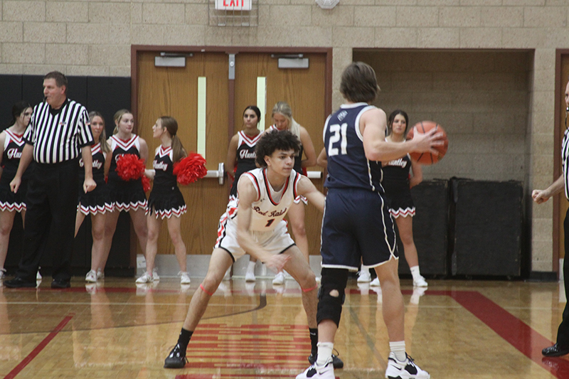 Huntley junior Lucas Crosby guards a Cary-Grove player in a Fox Valley Conference game. HHS downed the Trojans and Hampshire. Crosby led the Red Raiders with 18 points in a win over Hampshire.