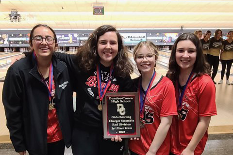 Huntley girls bowling team celebrates its first-place trophy at the Dundee-Crown Invite Dec. 3. Front row: Mackenzie Miller. Back row from left: Jessica Roberts, Katie Scaletta, Erica DeBello, head coach Asheley Bourdeau, Taylor Dulson, assistant coach Jason Waters, Prianca Waters,Tarah Wise, Grace Lehman, Kimber Schmid, Isabella Kuros, Katherine Harding.