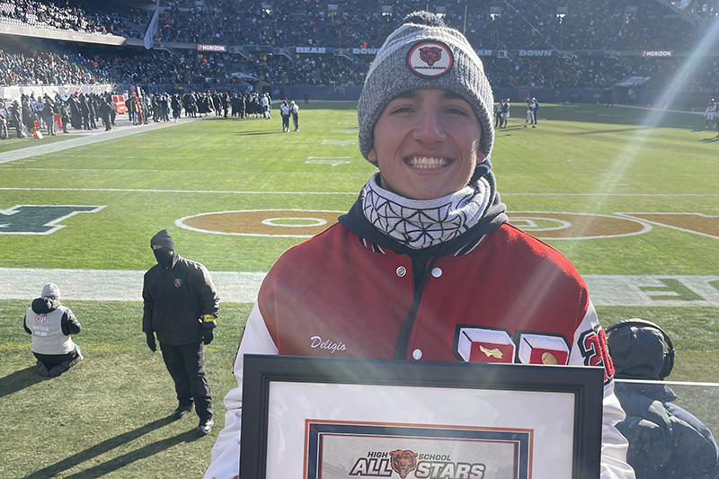 Huntley quarterback Sam Deligio shows his Chicago Bears weekly All-Star Player award received at a Bears game.