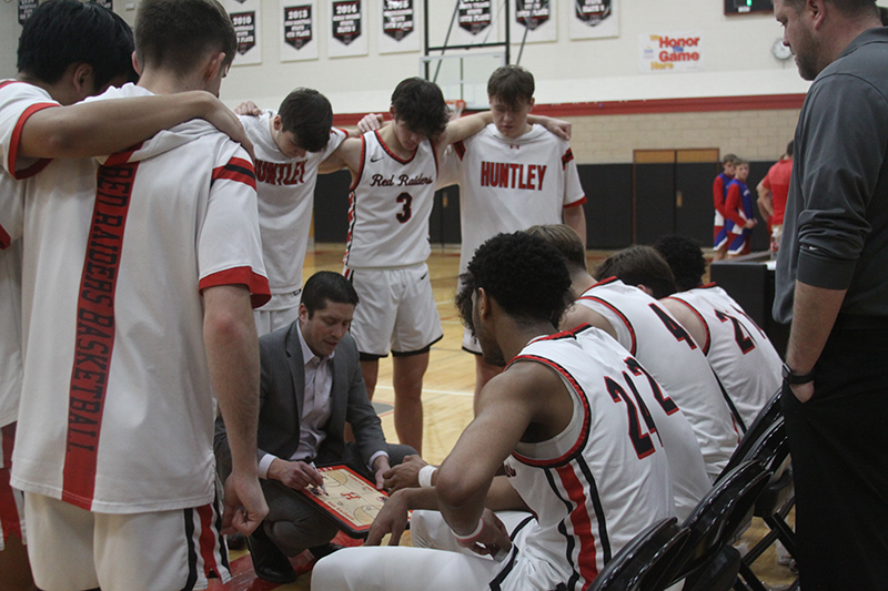 Huntley boys basketball coach Will Benson gives instructions during a final minute timeout against Dundee-Crown. The Red Raiders edged the Chargers 51-50 on Jan. 13.