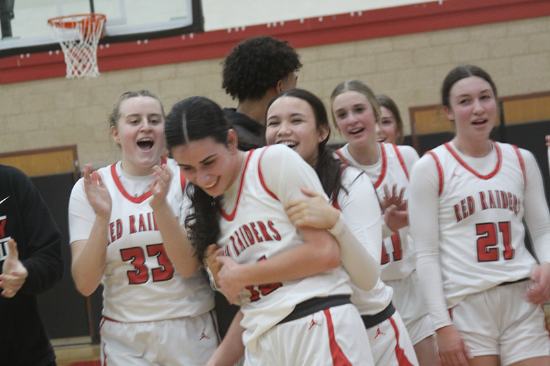 Huntley senior Jessie Ozzauto celebrates scoring her 1,000th point of her basketball career Feb. 6. Ozzauto scored 29 points as HHS downed Burlington Central, 68-39. From left: Mallory Winters, Alison Monis, Ozzauto, Anna Campanelli and Sammi Campanelli.