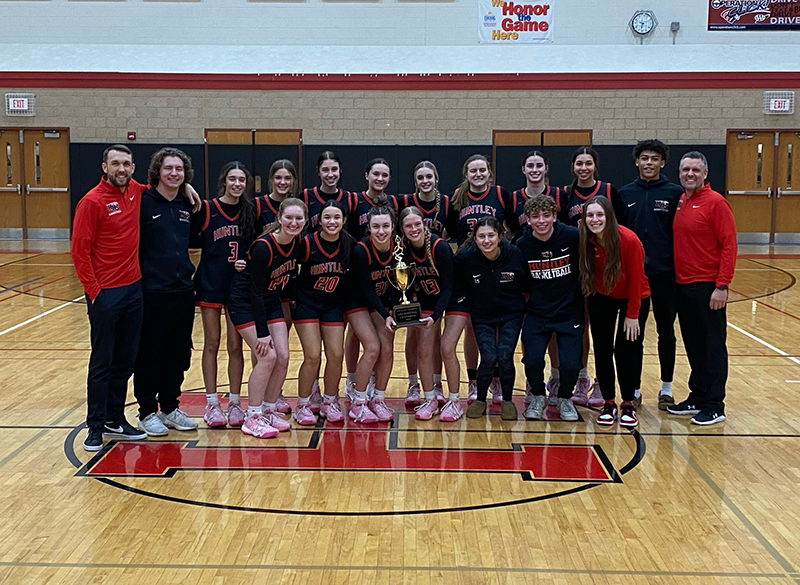 Huntley High School's girls basketball team celebrated a Fox Valley Conference championship Feb. 8. Front row from left: Isabella Boskey, Ali Minos, Sammi Campanelli, Morgan McCaughn, Alyssa Koop, manager Nick Kiobassa and coach Sam Green. Back row from left, coach Clay Henricksen, manager Zach Andrea, Cassidy Serpe, Ava McFadden, Gabriella Blitzer, Ashlyn Horton, Anna Campanelli, Mallory Winters, Jessie Ozzauto, Yasmine Morsy, manager Abraham Christian and coach Steve Raethz.