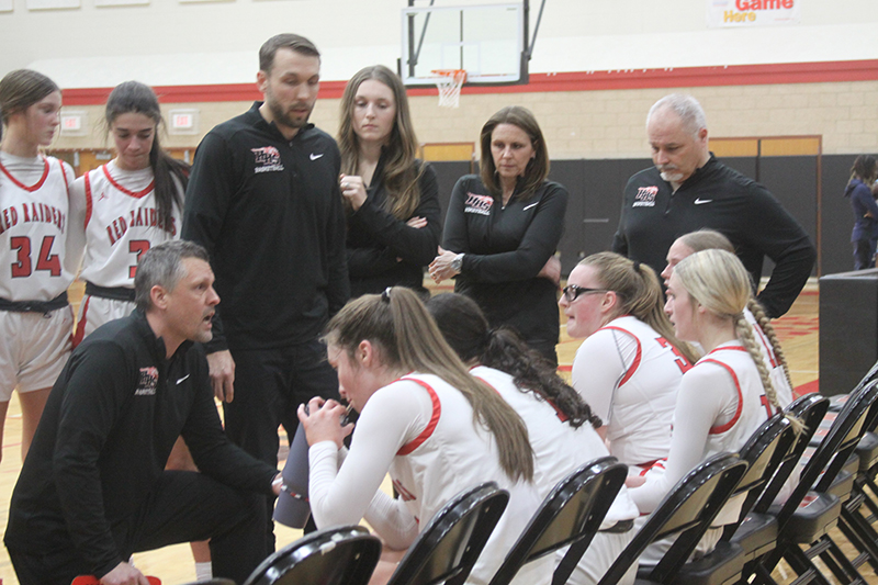 Huntley head girls basketball coach Steve Raethz gives the Red Raiders instructions during a fourth quarter timeout against Rockford Guilford. The visiting Vikings upset HHS in the Class 4A Huntley Regional final, 43-40, Feb. 17.