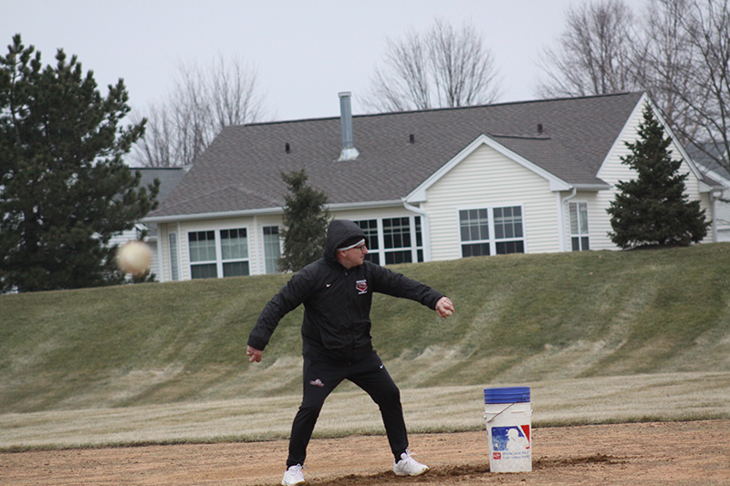 Huntley head baseball coach Andy Jakubowski works infielders on an outside practice session. The Red Raiders' home schedule, weather permitting, begins March 16 against Grayslake North.