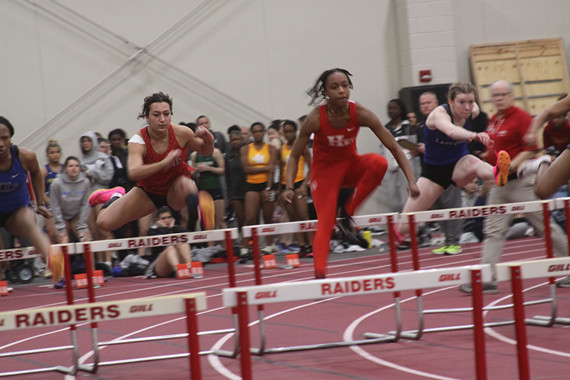 Huntley junior Sophie Amin clears a hurdle at the Huntley Girls Track Indoor Invitational. The Red Raiders won the team championship in the 18-team event March 11.