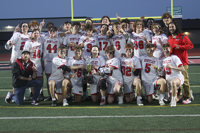 HHS players and coaches celebrate winning the Fox Valley Conference title. HHS finished 8-0 in league play with a 17-4 win over Crystal Lake South May 17.