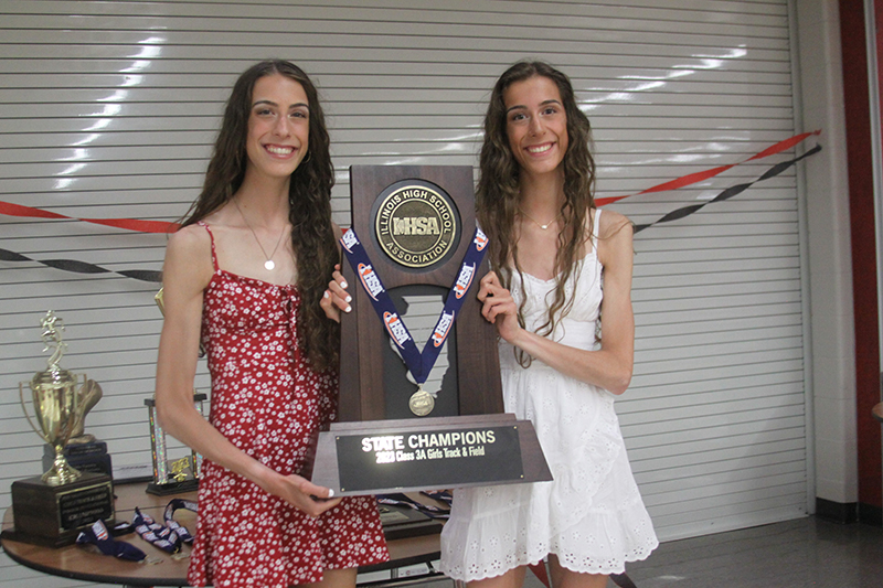 Breanna Burak, left and Brittney Burak, hold the Huntley's Class 3A State Track and Field Championship trophy.