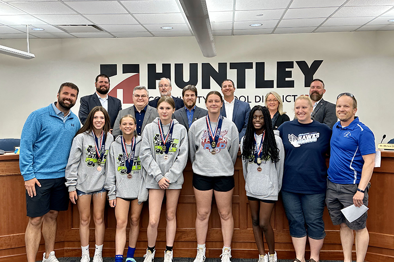 Heineman Middle School girls track and field team members competed at the Illinois Elementary School Association State Meet. They received recognition at the June 1 District 158 Board meeting. From left: team members Leila Useini, Amber Zaba, Evie Freundt, Reagan Ellis, Riley Galanis, Elena Fetzer, Chelsea Straus, Myla Wade, Mia Habel and Jordyn Slaughter. School board members,from left, Sean Crattu, Paul Troy, Tony Quagliano, Andy Bittman, Superintendent Dr. Scott Rowe, Laura Murray and Michael Thompson.