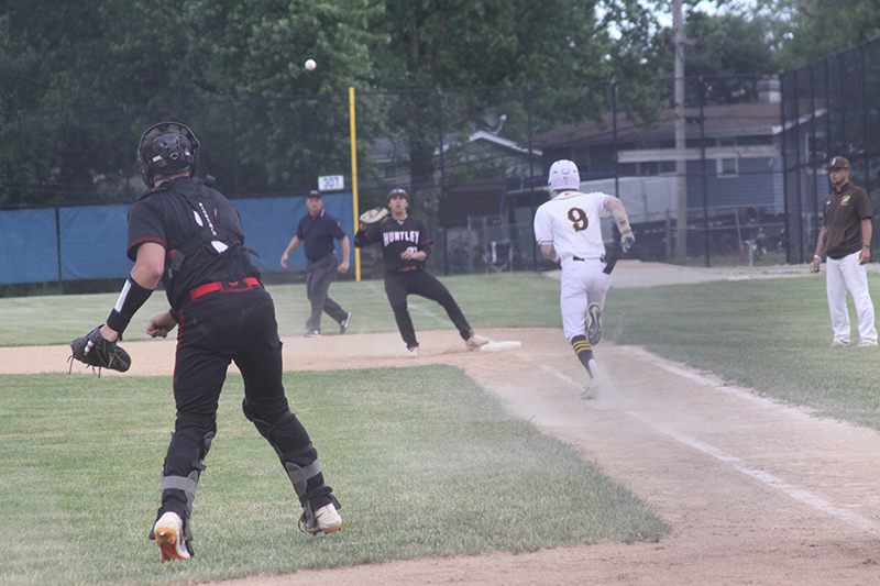 Huntley senior catcher Ryan Bakes throws to first baseman CJ Filipek for an out against Jacobs. Jacobs upset the Red Raiders 7-4 at the Dundee-Crown sectional semifinal May 31.