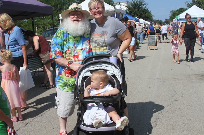 Santa Claus traded his red coat for an summer shirt at the Huntley Farmers Market's Christmas in July event. Santa meets Lindy, who looks at the market goings on and Danielle Lent of Huntley.