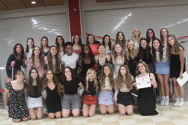 Huntley girls track and field members celebrates its state championship.