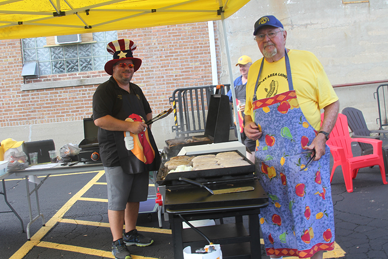 Huntley Area Lions Club members, John Nienhuis, left and Bill Lepola staff the grill at Beer and Brats Fest at Sew Hop'd Brewery and Taproom Aug. 5.