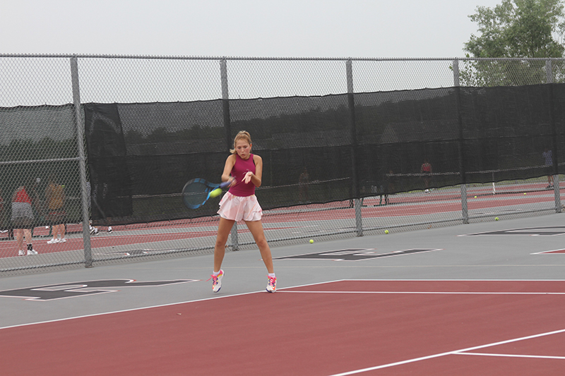 Huntley girls tennis player Julie Klockner returns a serve during a Red Raiders practice.