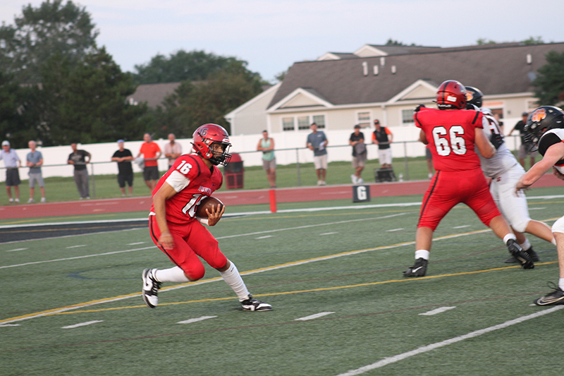 Huntley quarterback Braylon Bower carries the ball against Crystal Lake Central. The Red Raiders won 26-21 Aug. 25.