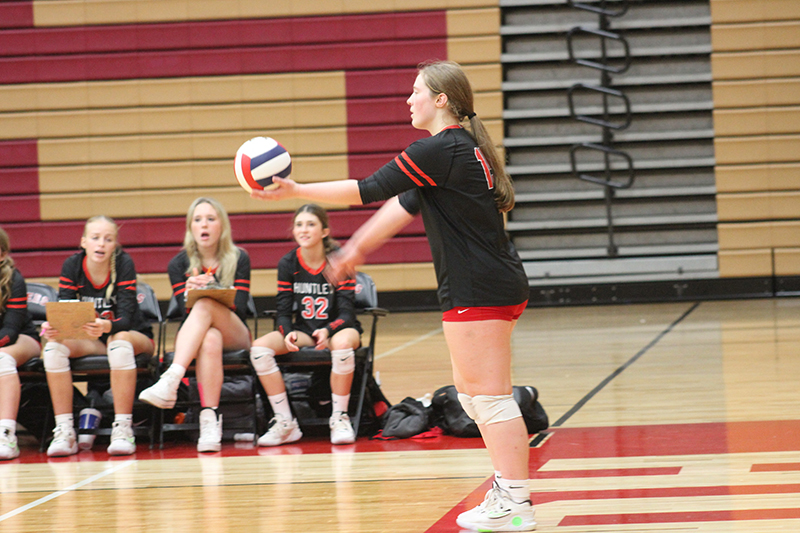 Huntley senior Lizzy Williams concentrates before serving against Barrington. Huntley won in three sets Sept. 20 to stay unbeaten.