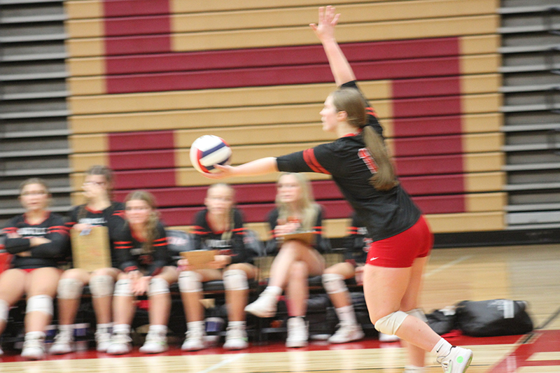 Huntley senior Lizzy Williams concentrates before serving against Barrington. Huntley won in three sets Sept. 20 to stay unbeaten.