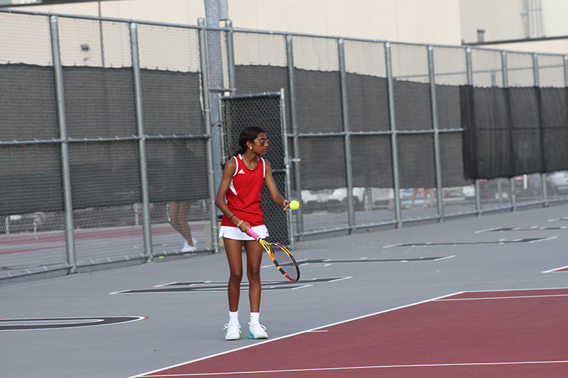 Gia Patel,a freshman, prepares to serve for the Red Raiders at No. 2 singles against St. Charles North.