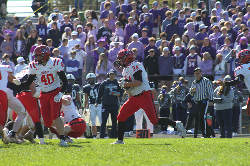 Huntley running back Haiden Janke (34) eludes Cary-Grove tacklers.